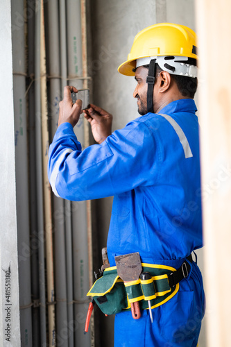 Photography Plumber busy taking photos of construction site for work reference for insurance claim - concept of measuring digitally using smartphone technology