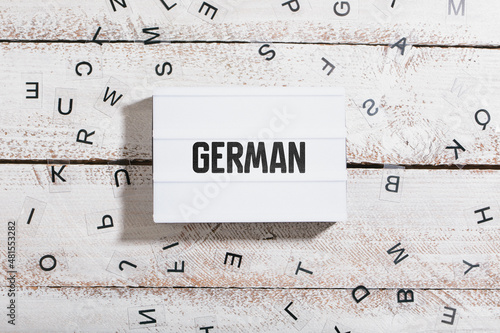 German word headline in light box on table with lettes photo