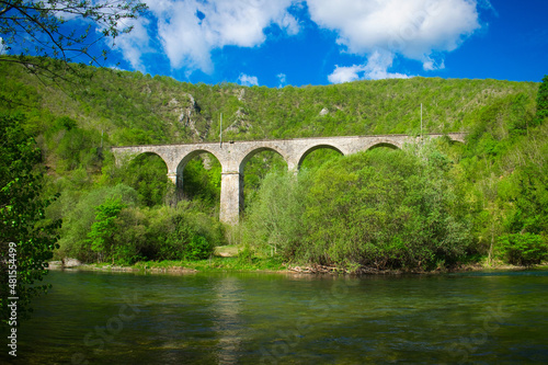 Old railway bridge over the mountain river Una in Bosnia and Herzegovina on a sunny day