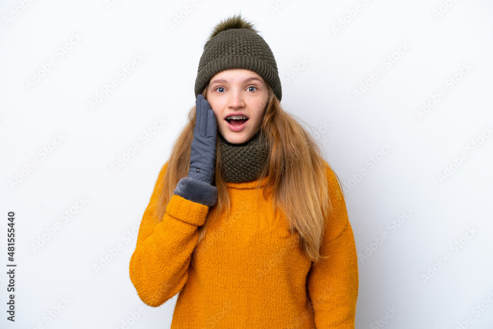 Teenager Russian girl wearing winter jacket isolated on white background with surprise and shocked facial expression Teenager Russian girl wearing winter jacket isolated on white background with surprise and shocked facial expression