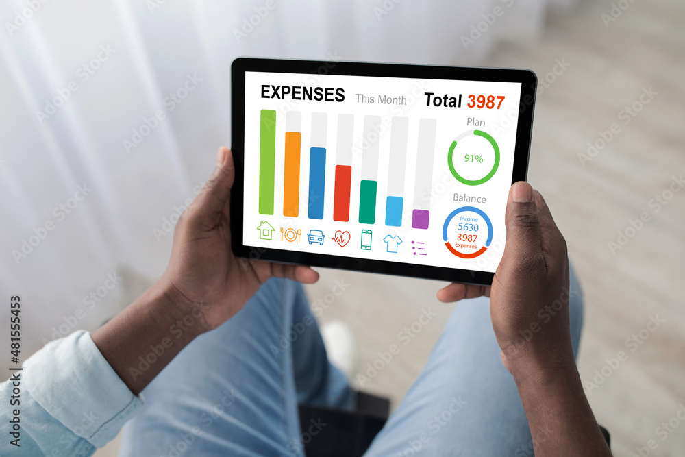Man in wheelchair using digital tablet at home, planning budget Man in wheelchair using digital tablet at home, planning budget