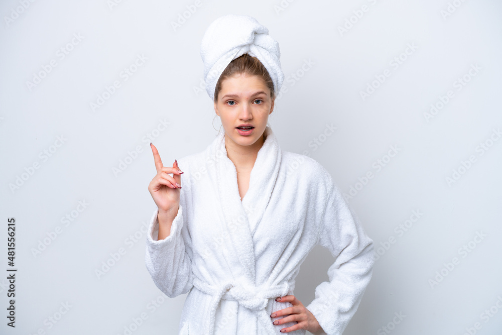 Teenager Russian girl in a bathrobe isolated on white background thinking an idea pointing the finger up Teenager Russian girl in a bathrobe isolated on white background thinking an idea pointing the finger up