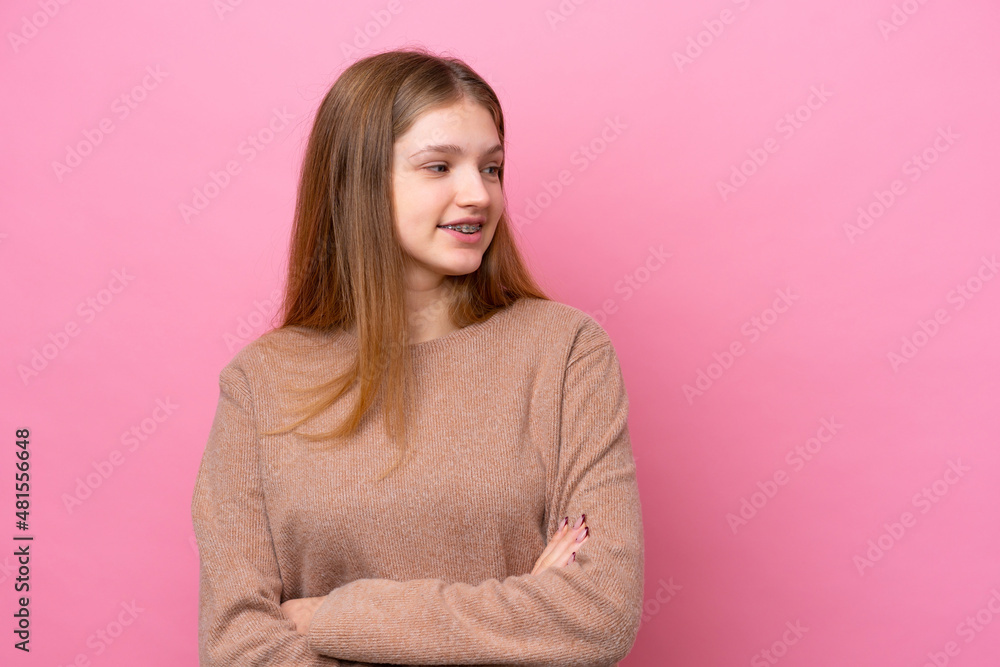 Teenager Russian girl isolated on pink background looking to the side Teenager Russian girl isolated on pink background looking to the side