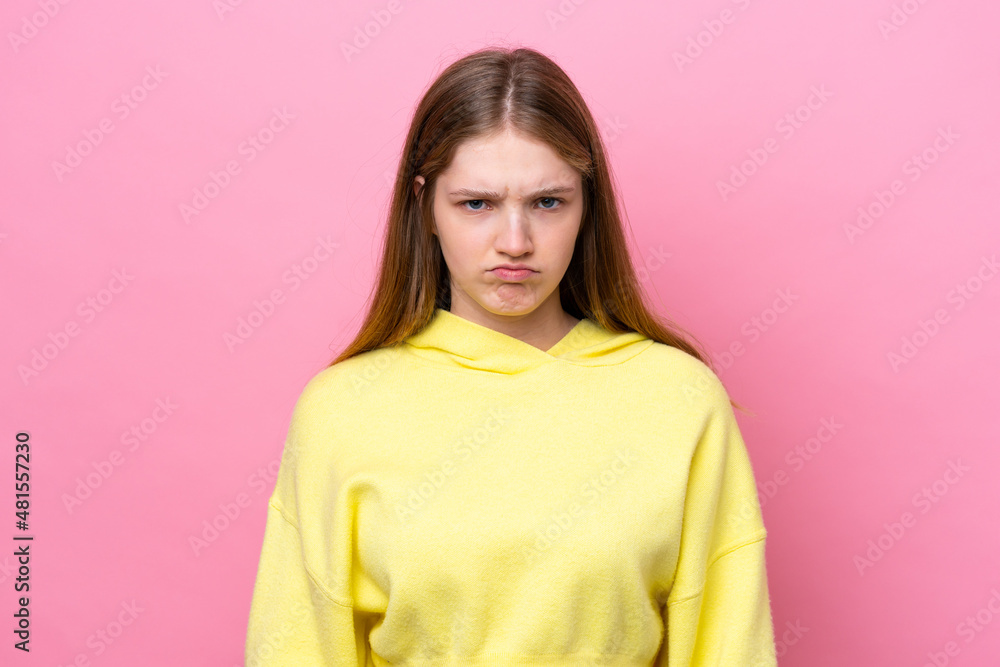 Fototapeta premium Teenager Russian girl isolated on pink background with sad expression