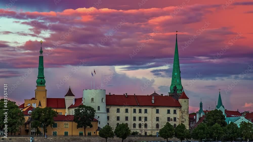 Beautiful view of old town of Riga, Latvia with Latvian flag blowing by Dome Cathedral and clouds passing by in timelapse. Beautiful view of old town of Riga, Latvia with Latvian flag blowing by Dome Cathedral and clouds passing by in timelapse.