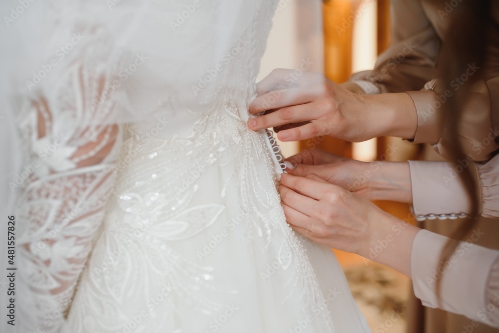 Bride dressing wedding gown. morning bride Bride dressing wedding gown. morning bride