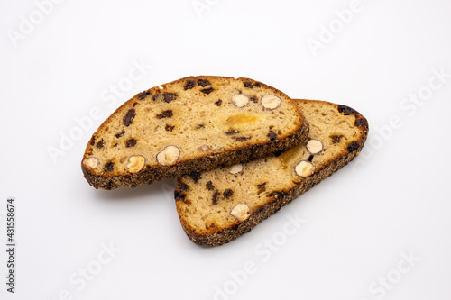 Slices of sweet dessert multigrain bread with nuts and raisins. Healthy diet. Isolated on white background.