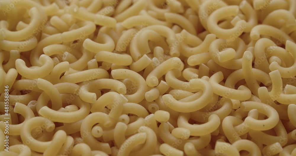 Macaroni Pieces Being Added To Heap Of Dried Pasta Macaroni Pieces Being Added To Heap Of Dried Pasta