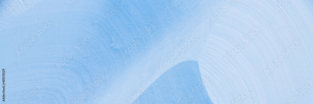 Beautiful winter background with snowy ground. Natural snow texture. Wind sculpted patterns on snow surface. Wide panoramic texture for background and design. Beautiful winter background with snowy ground. Natural snow texture. Wind sculpted patterns on snow surface. Wide panoramic texture for background and design.