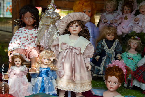 Vintage dolls on the market showcase. Antique toys are on sale.