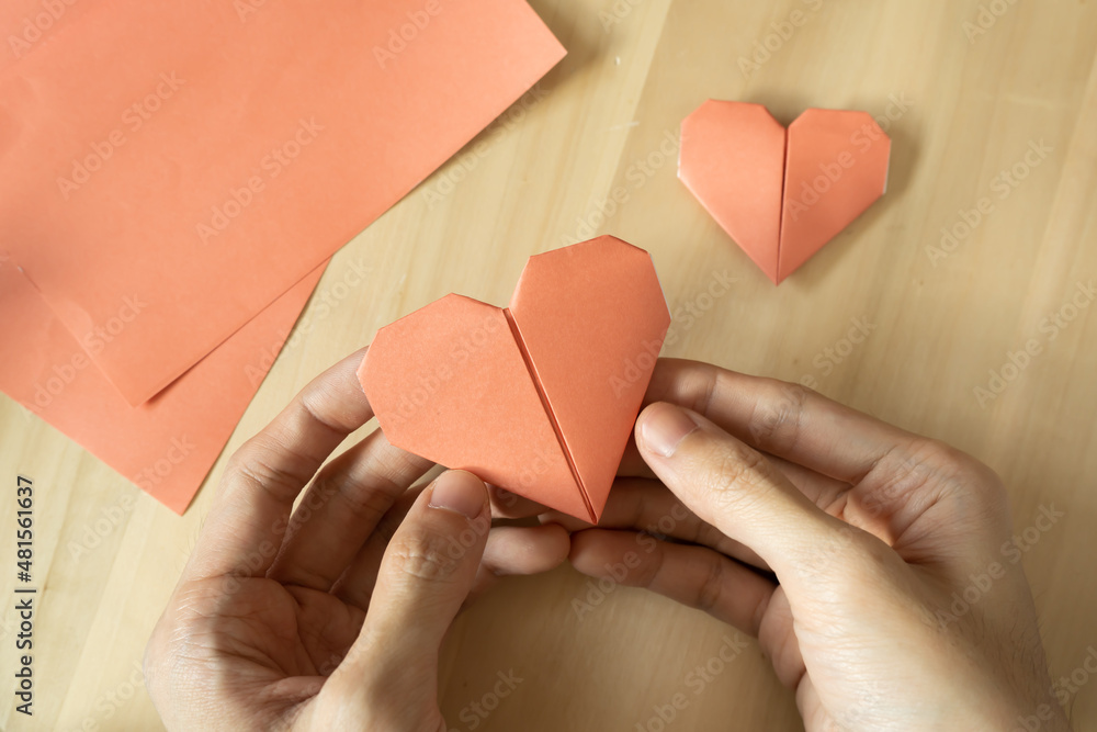 Folding Origami heart from pink paper