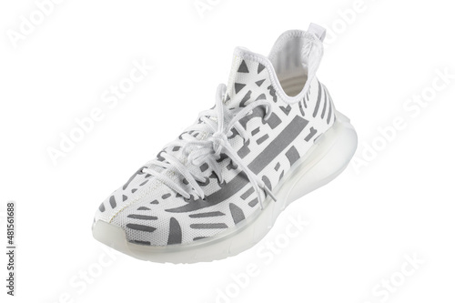 Sport shoes. White fabric trainers with gray reflective stripes.