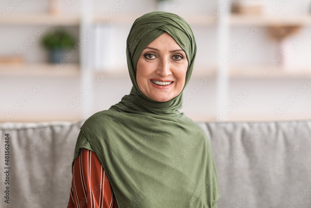 Portrait Of Happy Mature Middle-Eastern Woman Wearing Hijab At Home Portrait Of Happy Mature Middle-Eastern Woman Wearing Hijab At Home