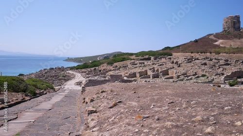 Archaeological area of Tharros with San Giovanni coastal tower in background in Protected marine area of the Sinis Peninsula, San Giovanni in Sinis, Cabras, Oristano, Sardinia, Italy photo