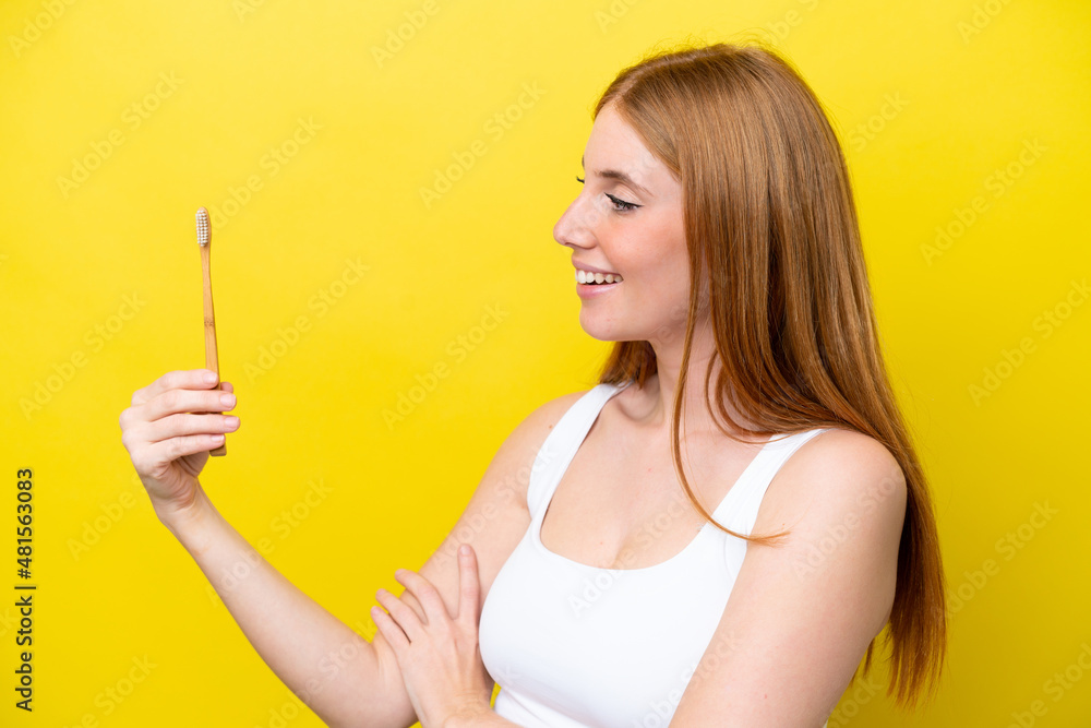 Young redhead woman brushing teeth with happy expression Young redhead woman brushing teeth with happy expression