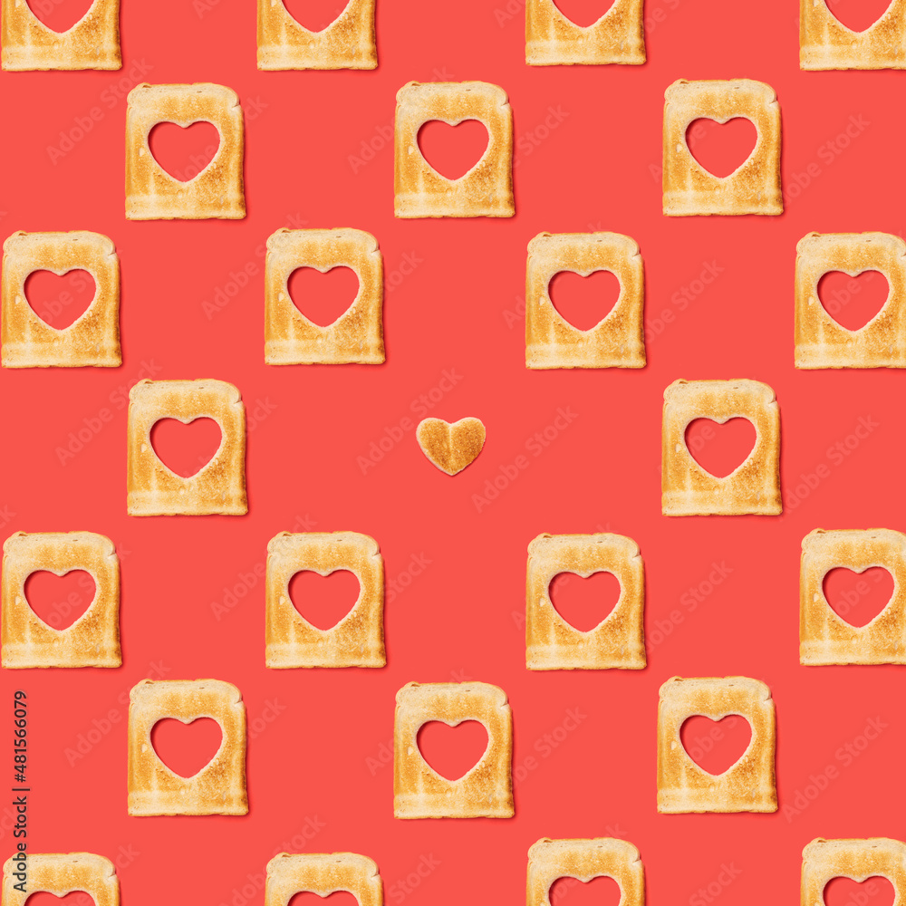 Romantic concept. Pattern made of many slices of toasted bread with a one heart shaped toast . Flat lay arrangement with lovely red background.