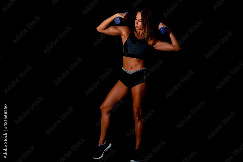 Brutal athletic woman pumping up muscles with dumbbells. Sexy attractive fitness woman, trained female body, lifestyle portrait, caucasian model. Brutal athletic woman pumping up muscles with dumbbells. Sexy attractive fitness woman, trained female body, lifestyle portrait, caucasian model.