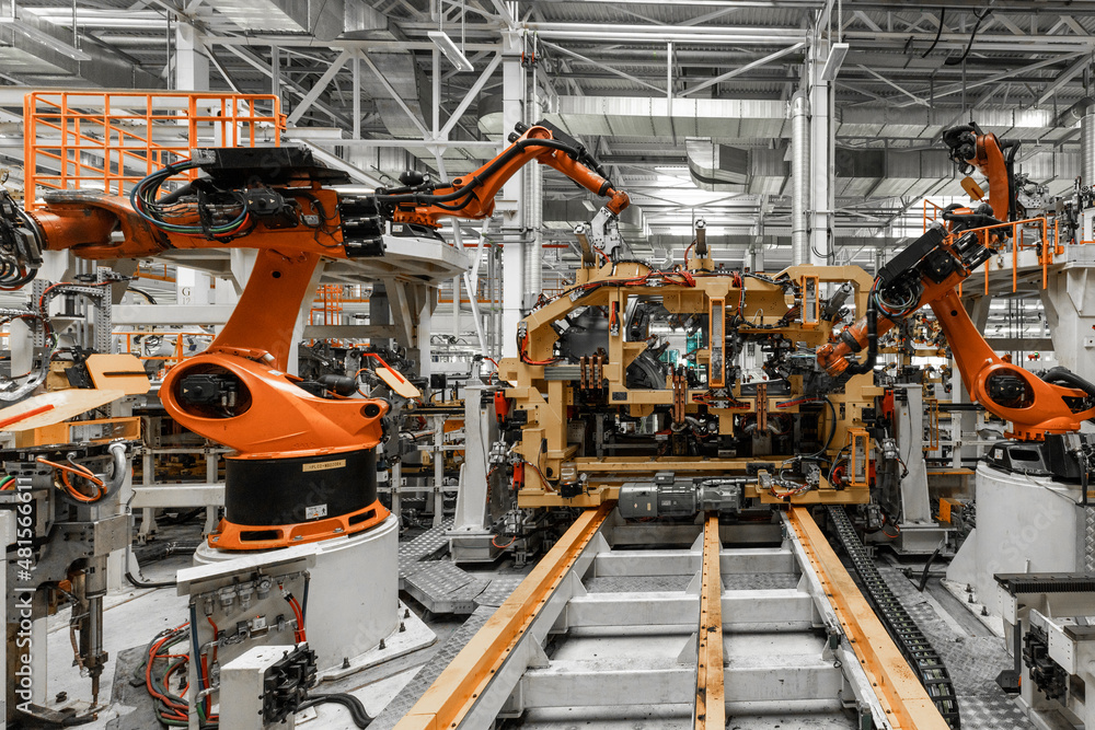 Photo of automobile production line. Welding car body. Modern car assembly plant. Auto industry