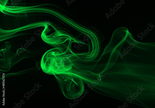 Green smoke abstract on black background for design. darkness concept