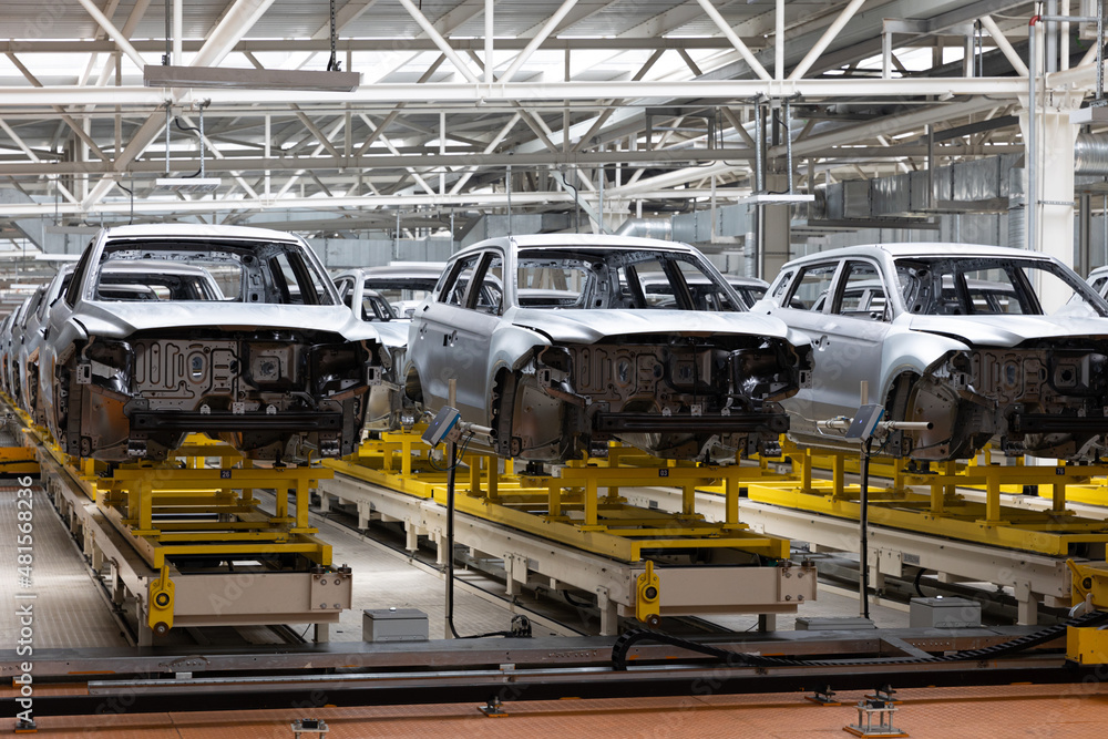 Photo of automobile production line. Welding car body. Modern car assembly plant. Auto industry. Interior of a high-tech factory Photo of automobile production line. Welding car body. Modern car assembly plant. Auto industry. Interior of a high-tech factory