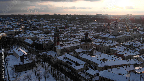 Aerial shot of Old City Lviv cowered by snow with churches and cathedrals.