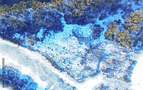 Aerial view of the texture of frozen wildlife in winter. Photo of ice and snowy river from above