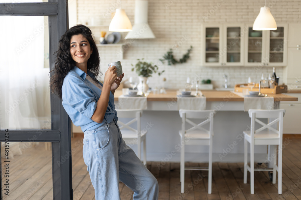 Beautiful young lady relaxing with cup of coffee at home, copy space Beautiful young lady relaxing with cup of coffee at home, copy space
