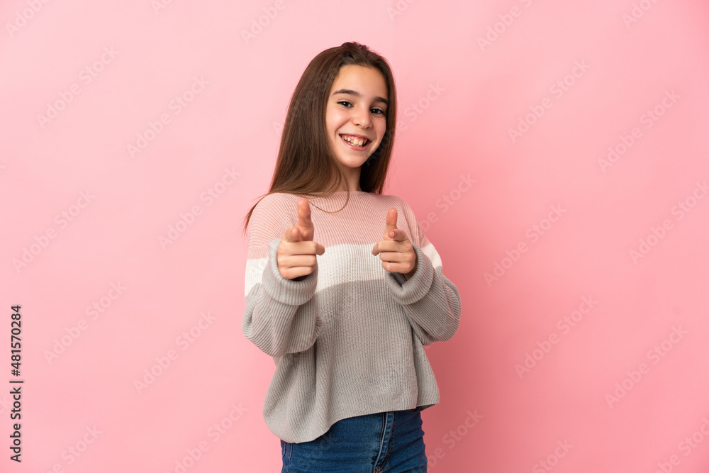 Little girl isolated on pink background surprised and pointing front Little girl isolated on pink background surprised and pointing front