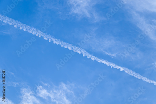 Sky with airplane tracks and clouds. © kvdkz