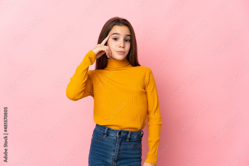 Little girl isolated on pink background thinking an idea Little girl isolated on pink background thinking an idea