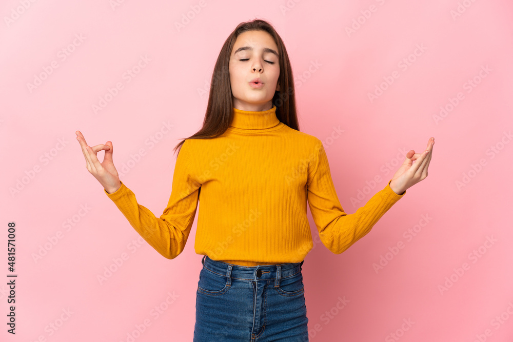 Little girl isolated on pink background in zen pose Little girl isolated on pink background in zen pose