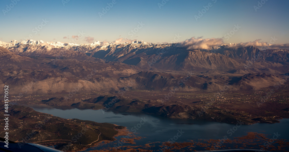 Beautiful aerial landscape view of Skadar lake, Montenegro. Aerial view mountains and lake from airplane. Aerial View from airplane