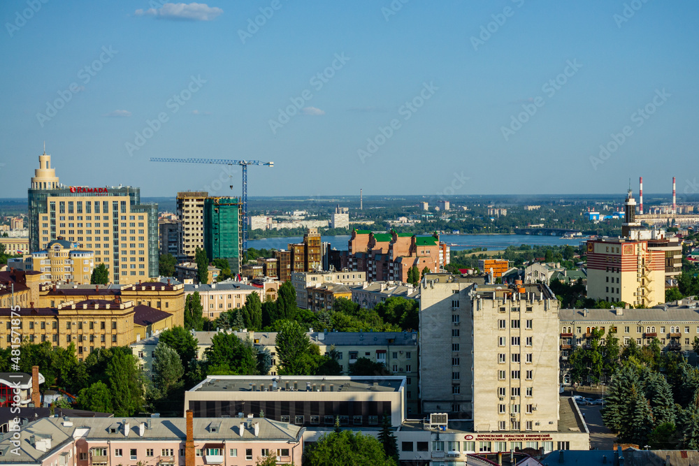 Voronezh, Russia, June 11, 2019: View on high-rise buildings on right bank of river. Modern high-rise buildings built inside old urban neighborhoods surrounded by five-story residential buildings.