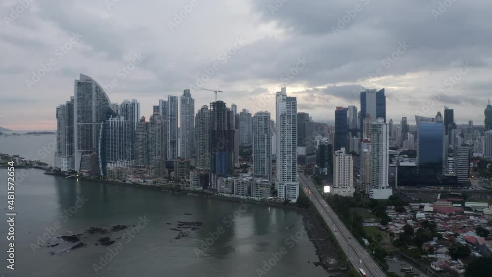 Aerial view of panama city with cars driving with a large crane, pullback wide shot Aerial view of panama city with cars driving with a large crane, pullback wide shot
