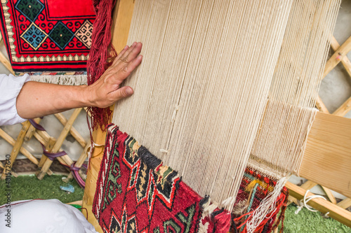 Making a carpet by hand in a Kazakh yurt