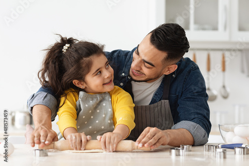 Baking Fun. Arab Dad And Little Daughter Preparing Dough Together In Kitchen