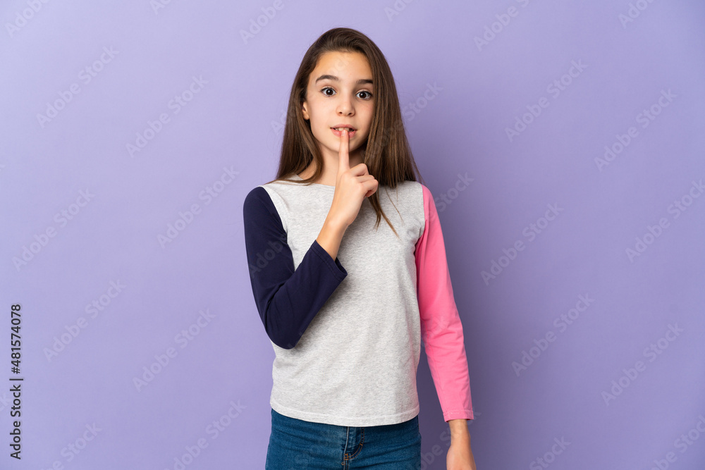 Little girl isolated on purple background showing a sign of silence gesture putting finger in mouth Little girl isolated on purple background showing a sign of silence gesture putting finger in mouth
