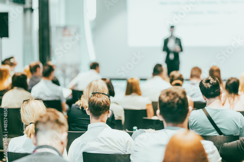 Business speaker giving a talk at business conference event.