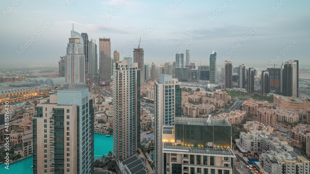 Obraz premium Aerial view of a big futuristic city day to night timelapse. Business bay and Downtown