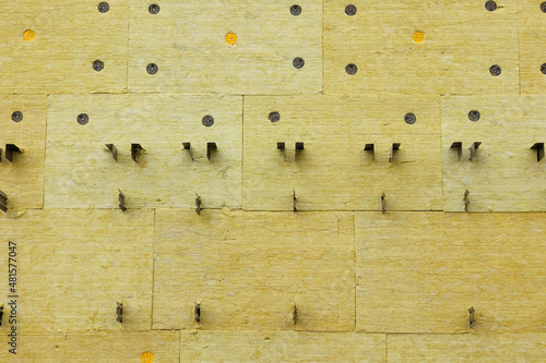 Wall insulation with mineral wool and installation of a hinged ventilated facade system. Background of stone wool tiles