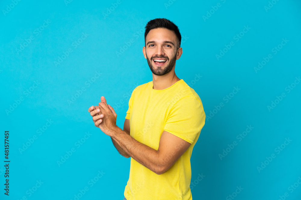 Young caucasian man isolated on blue background applauding Young caucasian man isolated on blue background applauding