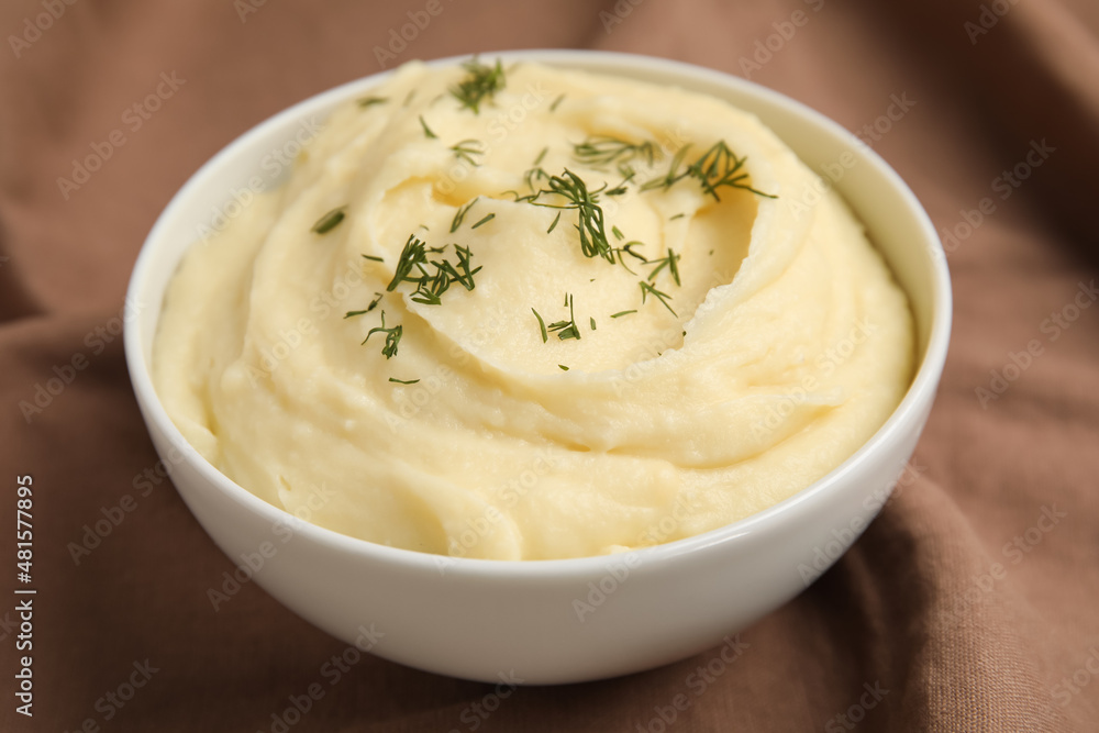 Freshly cooked homemade mashed potatoes on brown fabric Freshly cooked homemade mashed potatoes on brown fabric