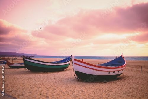 Wooden boats on the beach during sunset