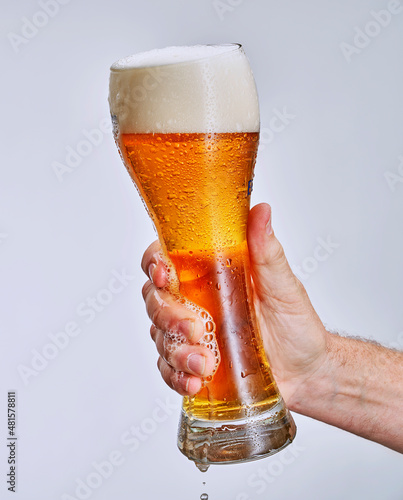 hand holding glass of beer photo