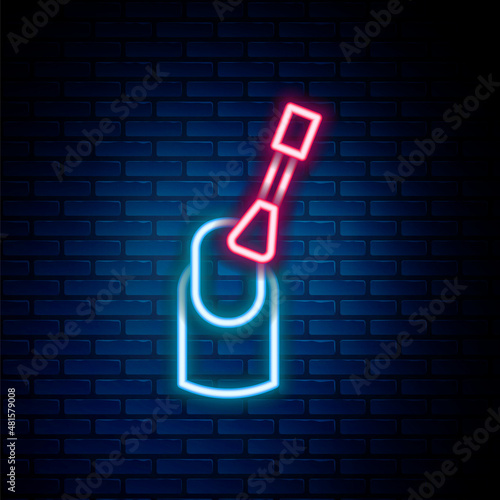 Glowing neon line Nail manicure icon isolated on brick wall background. Colorful outline concept. Vector