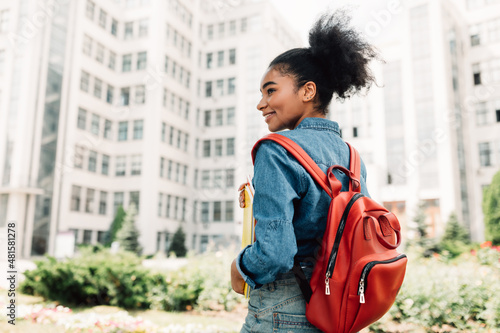 Student Girl Posing With Backpack Standing Back To Camera Outside
