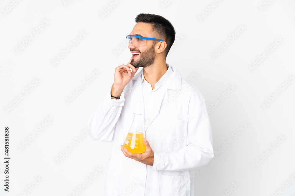 Young scientific man isolated on white background thinking an idea while looking up