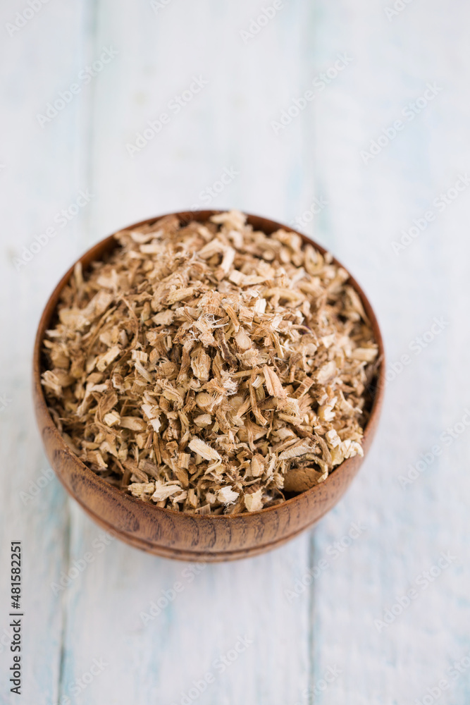 Chopped licorice root remedy on white background Chopped licorice root remedy on white background