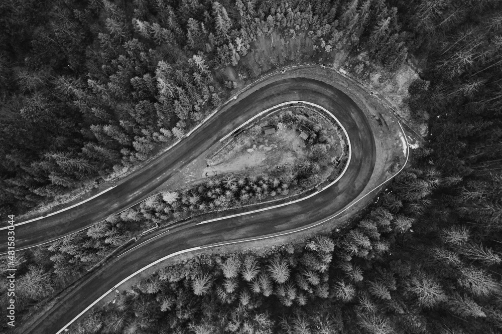 Obraz premium Picturesque mountains and serpentine roads, forest and road in the fog, steep turns of roads, road in the mountains.