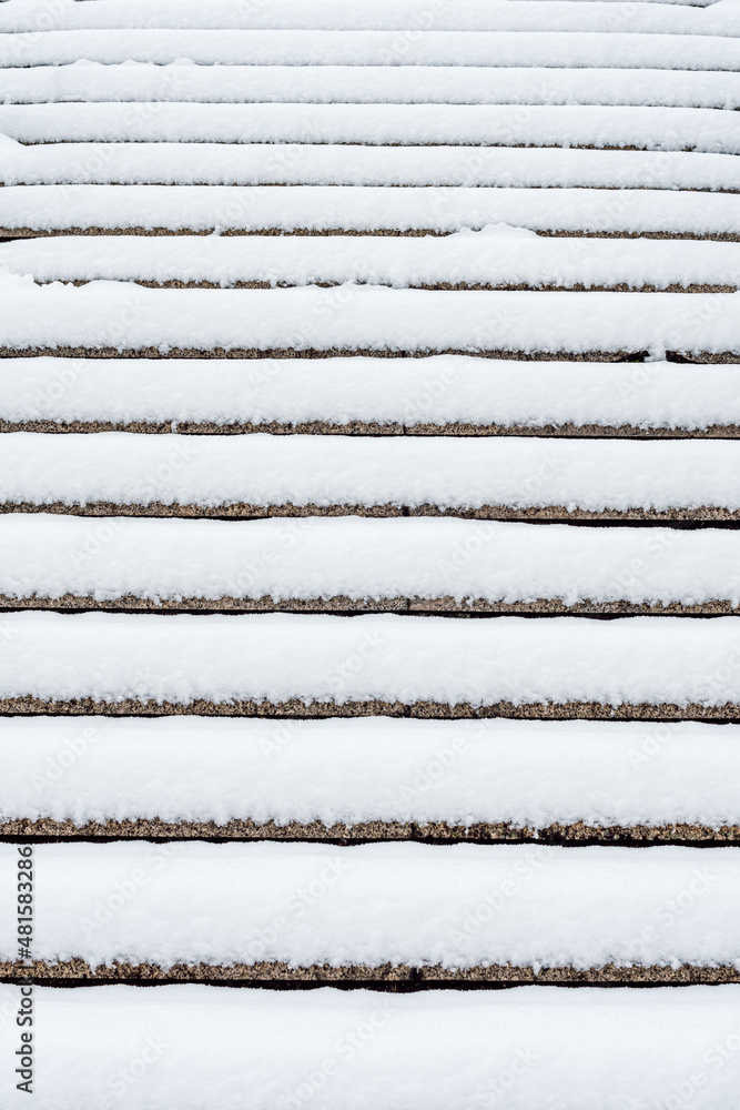 Cement steps covered with freshly fallen snow. Steps not cleaned of snow, risk of slipping.
